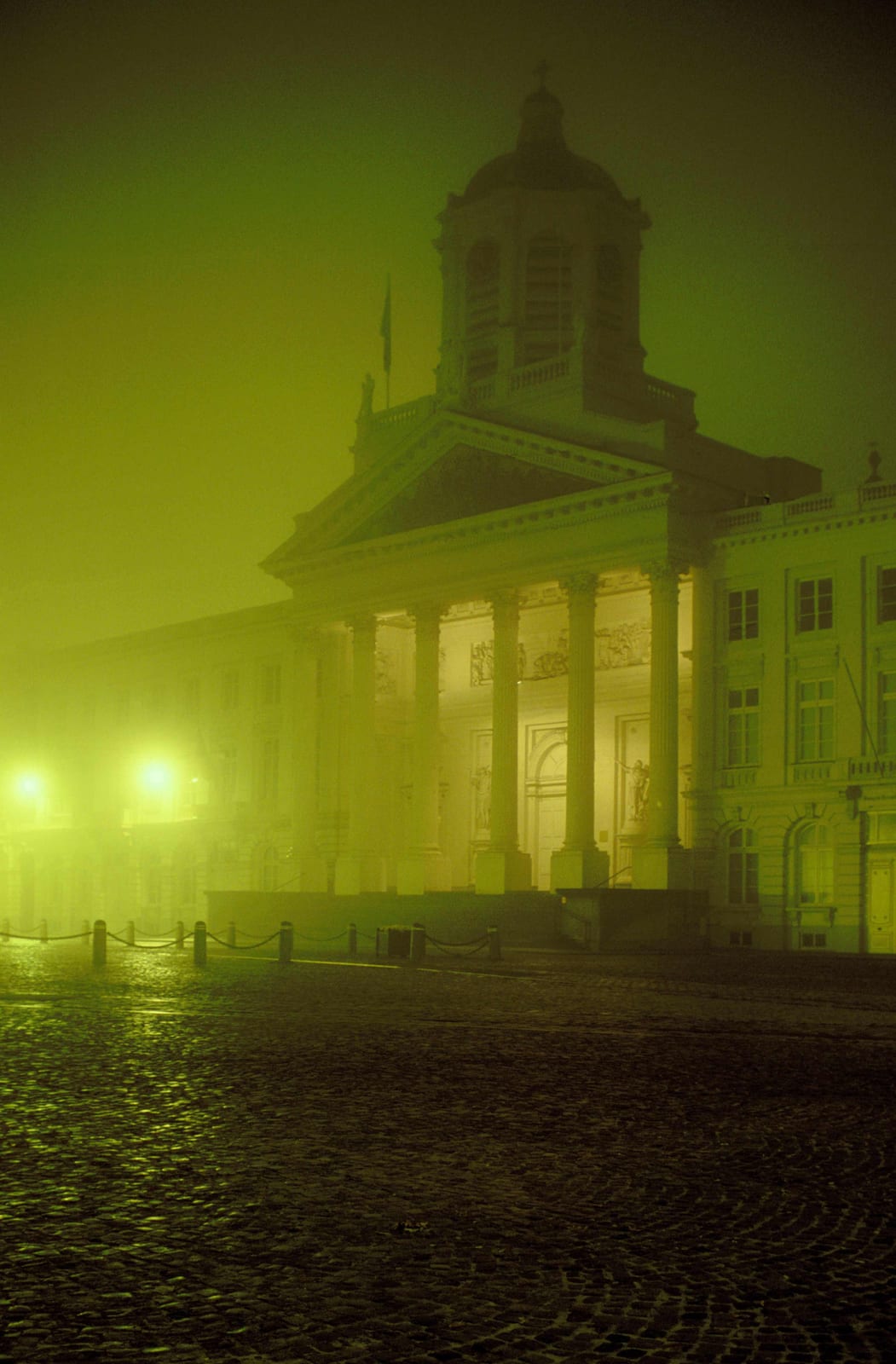 Un édifice à coupole et colonnes émergeant d’un brouillard vert
